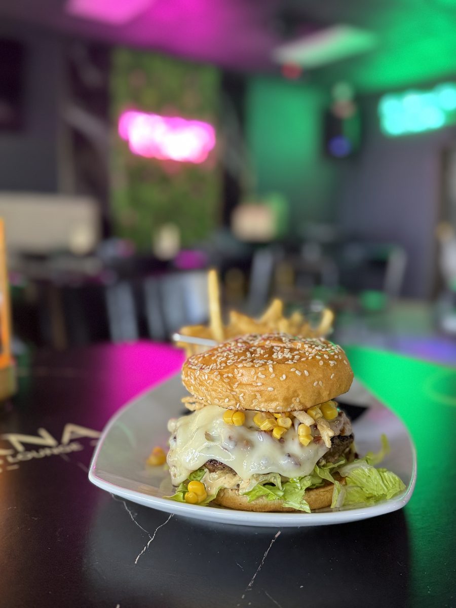 Eterna SmashBurger with melted cheese and neon lounge lights