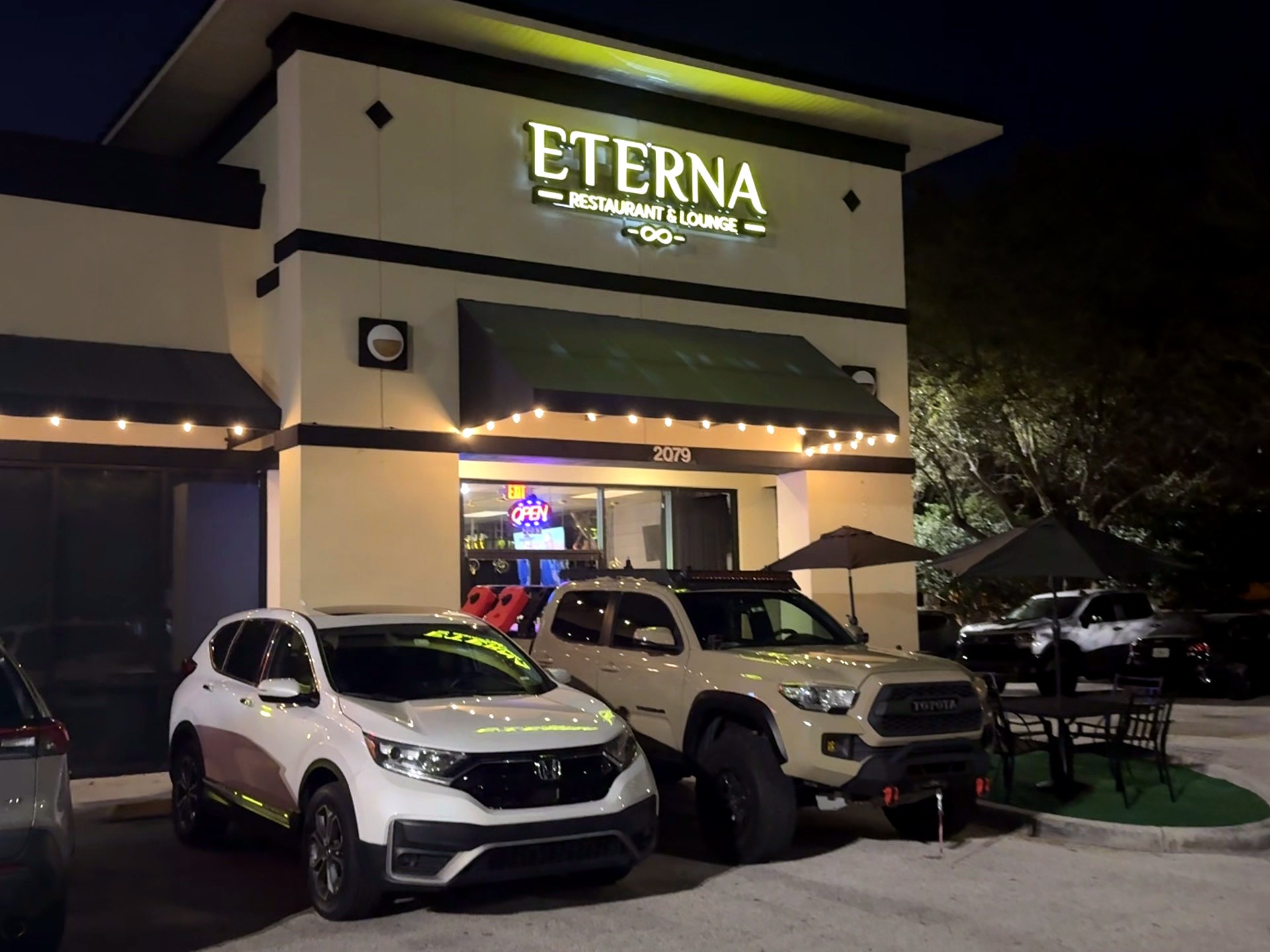 Eterna Restaurant & Lounge storefront lit up at night at 2079 E Osceola Pkwy in Kissimmee